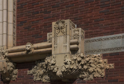 Terra cotta ornament to the side of stained glass windows