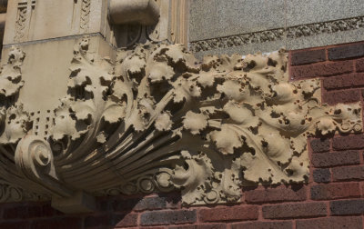 Terra cotta ornament to the side of stained glass windows, detail