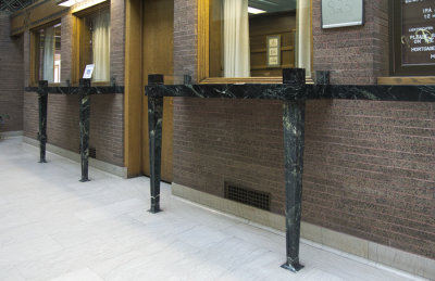 Customer writing desks, stained glass side toward rear
