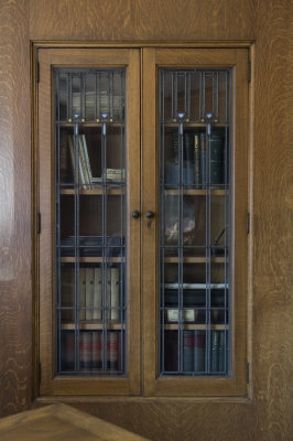 Oak bookcase with leaded and stained glass in conference room