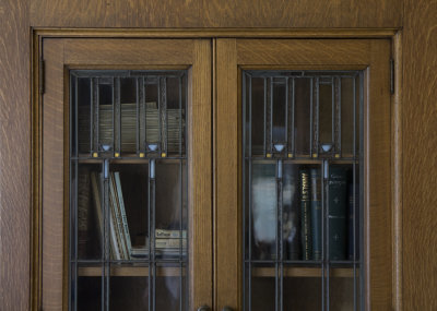 Oak bookcase with leaded and stained glass in conference room, detail