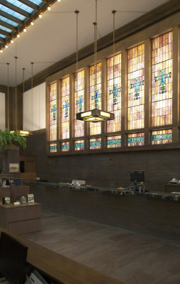 Side wall of bank interior with stained glass windows