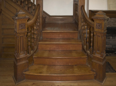 Foyer: Lower flight of stairs with newel posts