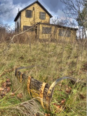 Abandoned Yellow House and Barrel