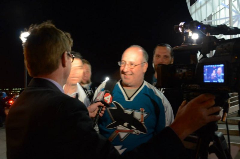 Local TV reporter interviews a fan and a hockey writer soon after the win