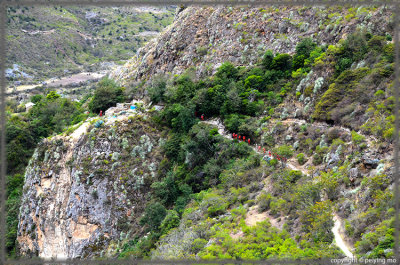 Porters (in red) carrying the necessary equipment and food supplies for campers