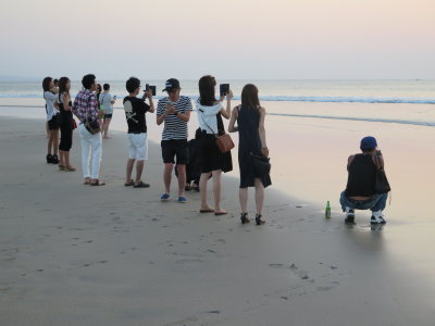 taking pics of sunset Kuta beach Bali