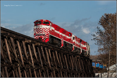 The 7002 leads a heavy train across the Milwaukee trestle. 