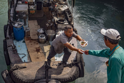 Cook-aboard sampan delivering hot lunch, Typhoon Shelter style