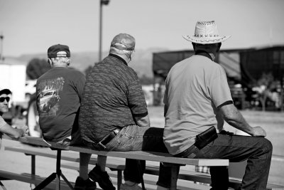 Three guys watching tractors
