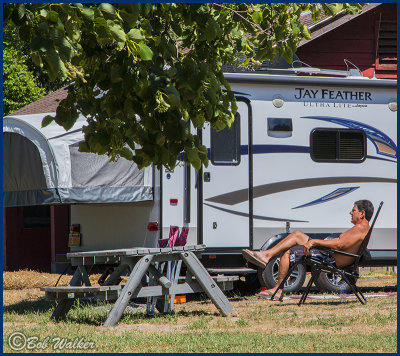 A Camper Enjoying The Weather And A Campsite