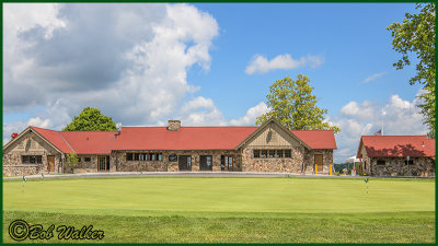 A View Of The Clubhouse With A Practice Green In Front 