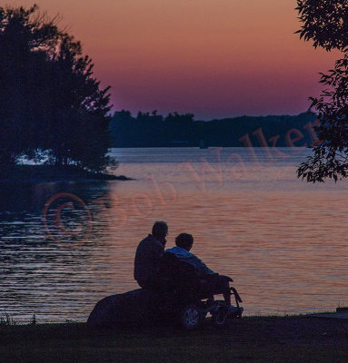 A Handicap Women Enjoying A Sunset With Her Loving Husband