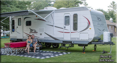 A Happy Couple And Their Beautiful Camper