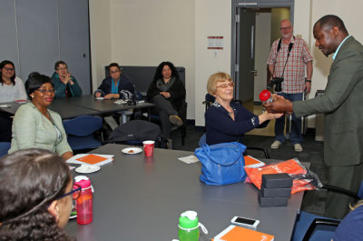 NorQuest Social Work Chair David Flomo presenting a coffee mug.