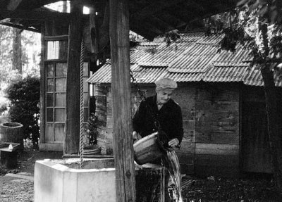 Japanese man drawing water at his well