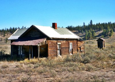 Whitney Ghost Town home and outhouse.JPG