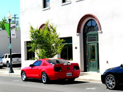 Red Ford Mustang in front of 10 Bartlett