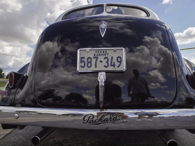 I like the image. Too bad the photogs are reflected  in the car.