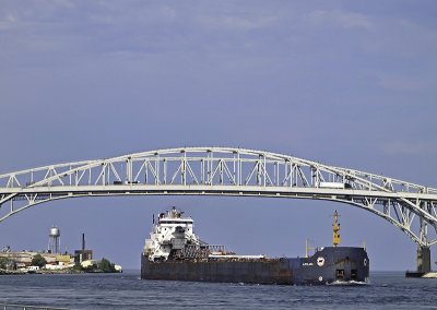 A Lake Freighter (Laker) steams from Lake Huron under the blue Water bridge into St  Clair river at Port Huron.