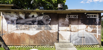 This mural was found on the rear wall of the Hobo Junction  Restaurant  in Liberty Hill, TX. It sits next to the local railroad