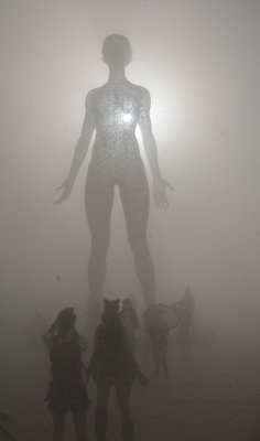 Over 30 ft tall Steel Female Nude Sculpture in Deep Playa-Sun Heart in Dust Storm