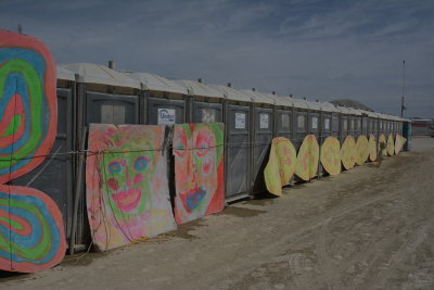 If you can't put art on the portapotties you can surely put it next to them