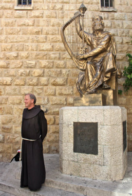 Father David standing by statue of King David.  This is one of his possible burial sites (King David, that is).