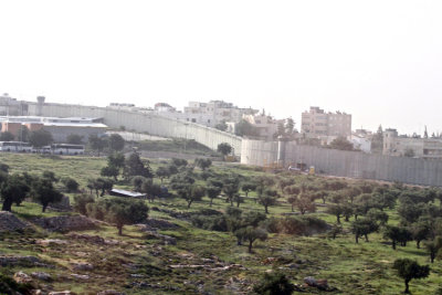 Driving from Bethlehem, in Palestinian territory, to Israel- the wall can be seen at a distance.