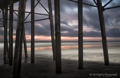 Early Dawn Breaking Under Pier