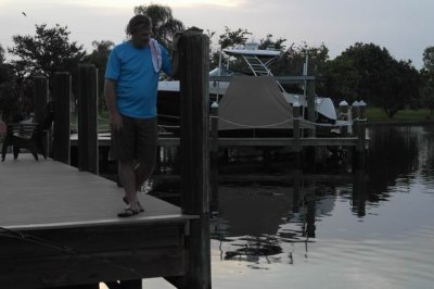 Papi on the dock with a gator in the water