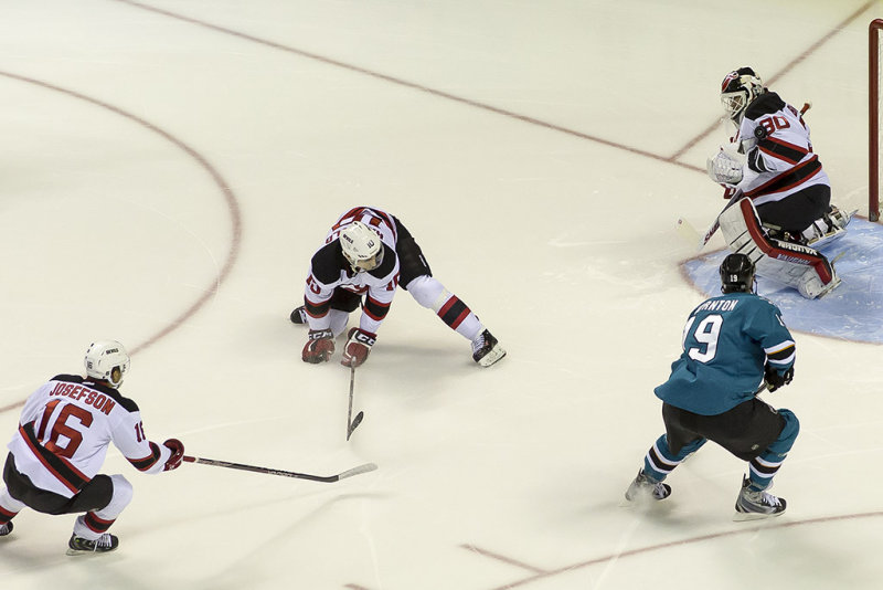 Martin Brodeur makes a save on a shot by Brent Burns