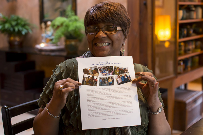 Yvonne displaying 50th class reunion flyer