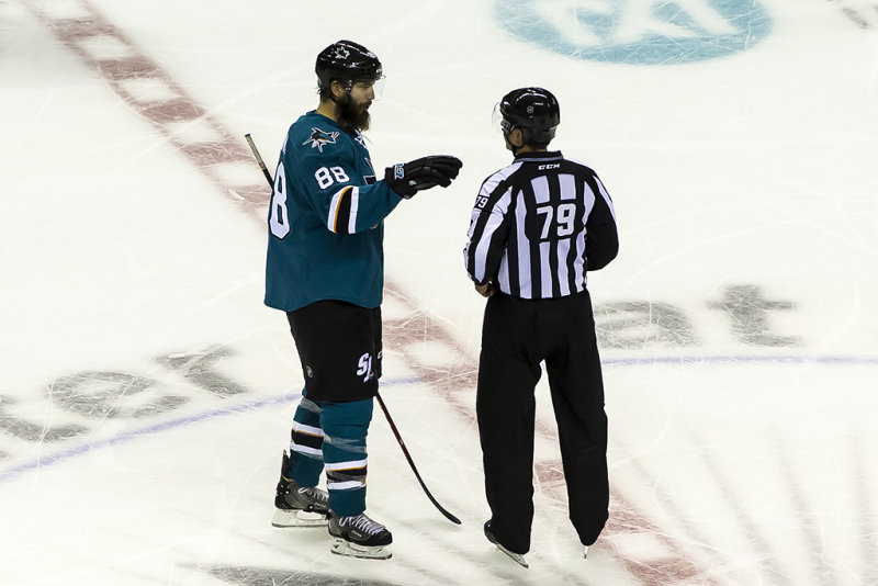 Brent Burns is having a discussion with the Linesman
