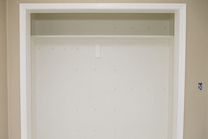 Wire shelf brackets in closet wall