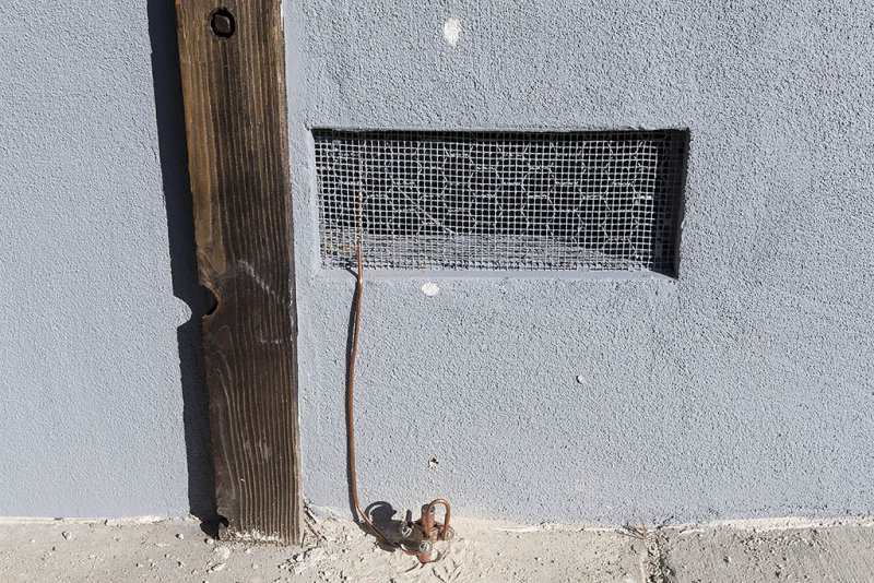 Metal rod driven into the ground for the service entrance