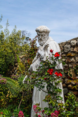Statue of a saint cradling a Crucifix at Mission Carmel Catholic church  _MG_8240.jpg