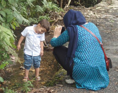 5367: Mother photographing wet-ankled boy