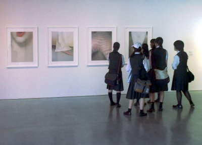 Uniformed schoolgirls ponder contemporary art