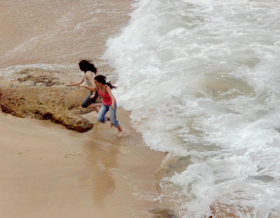 Two girls and a small wave