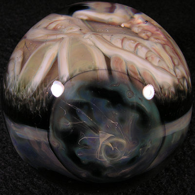 Three stormy planets ring the equator of the marble.