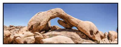 Arch Rock framed by the midday sky in Joshua Tree National Park