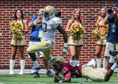 Yellow Jackets A-back Dennis Andrews breaks a tackle by Elon LB Odell Benton