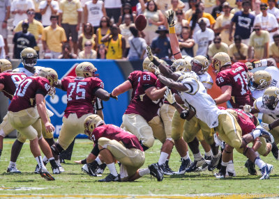 Yellow Jackets line surges to disrupt a field goal attempt by Elon K John Gallagher