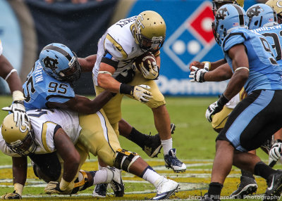 Yellow Jackets RB Zach Laskey attempts to break away from Tar Heels DE Kareem Martin