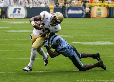 Yellow Jackets RB Synjyn Days is tackled by Tar Heels S Green