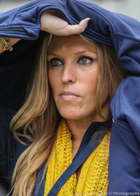 Yellow Jackets Fan tries to stay dry as she watches the game