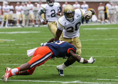 Tech B-back Sims works to escape the tackle of Syracuse FS Eskridge 