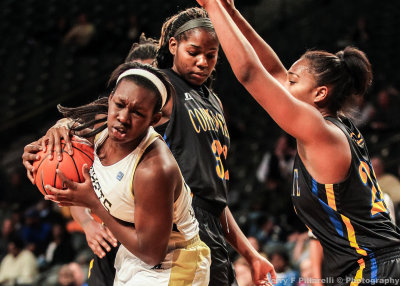 Yellow Jackets F Gabrielle Holston is challenged under the basket by Eagles defenders