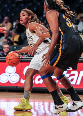 Yellow Jackets F Rogers is defended by Eagles F Omaah Tayong